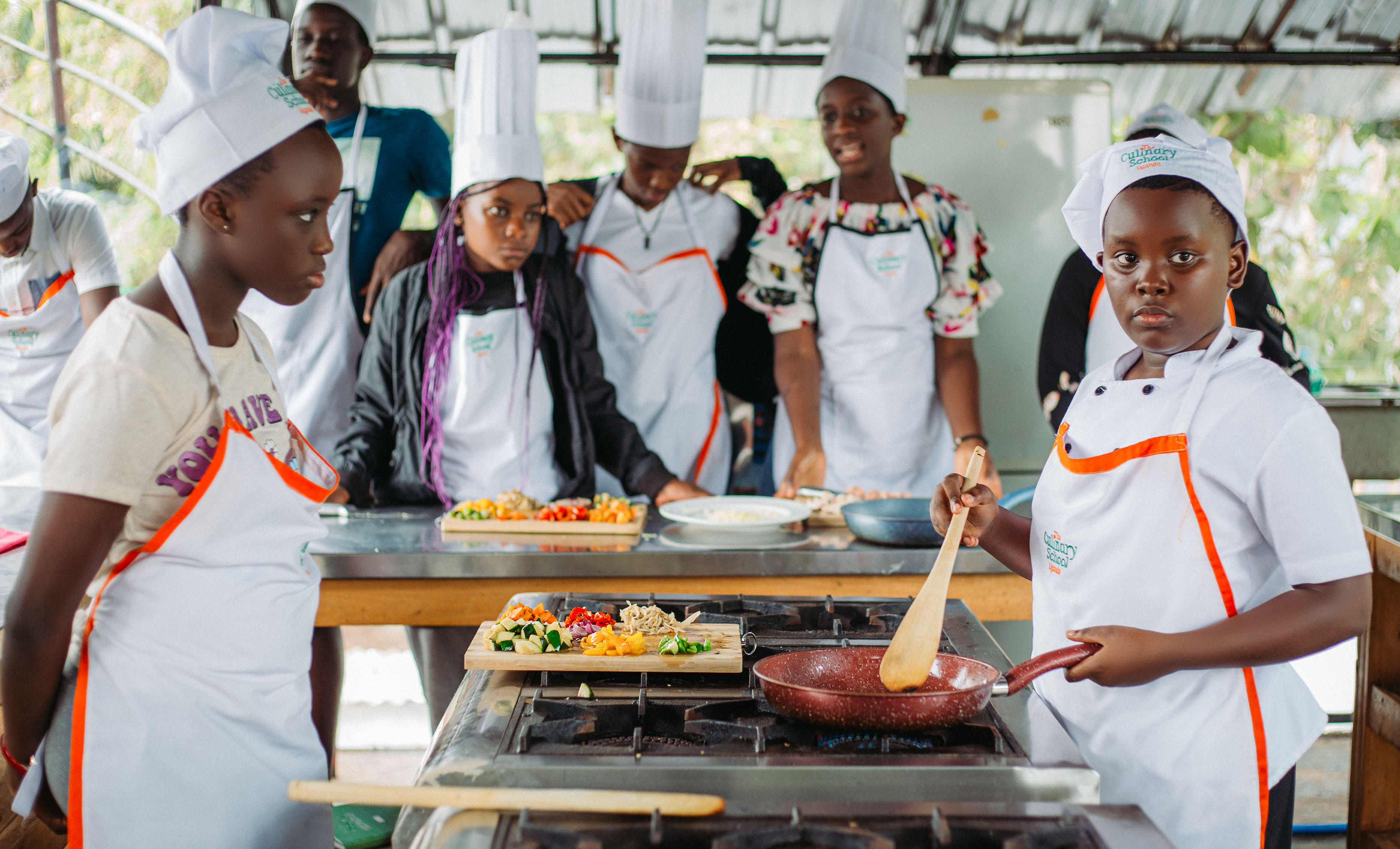 DJ facing a crowd at his deck. Photo with a purple hue