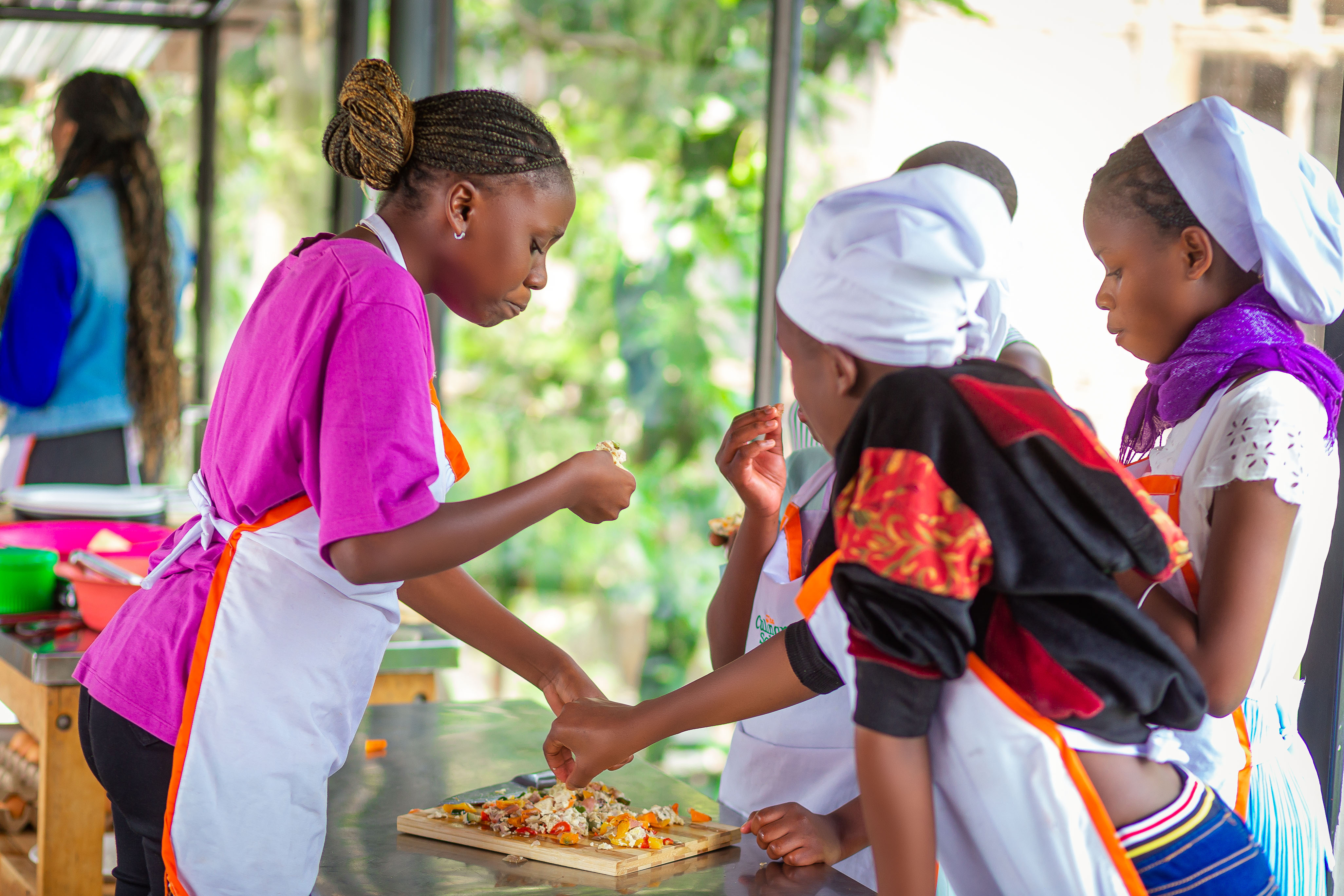 People at a concert facing the stage with various colours of paint powder in the air